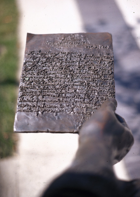 Detail of the Jack Trice memorial statue on Iowa State campus, featuring a hand holding Trice's "last letter." The statue was financed by students' fundraising efforts in 1988.